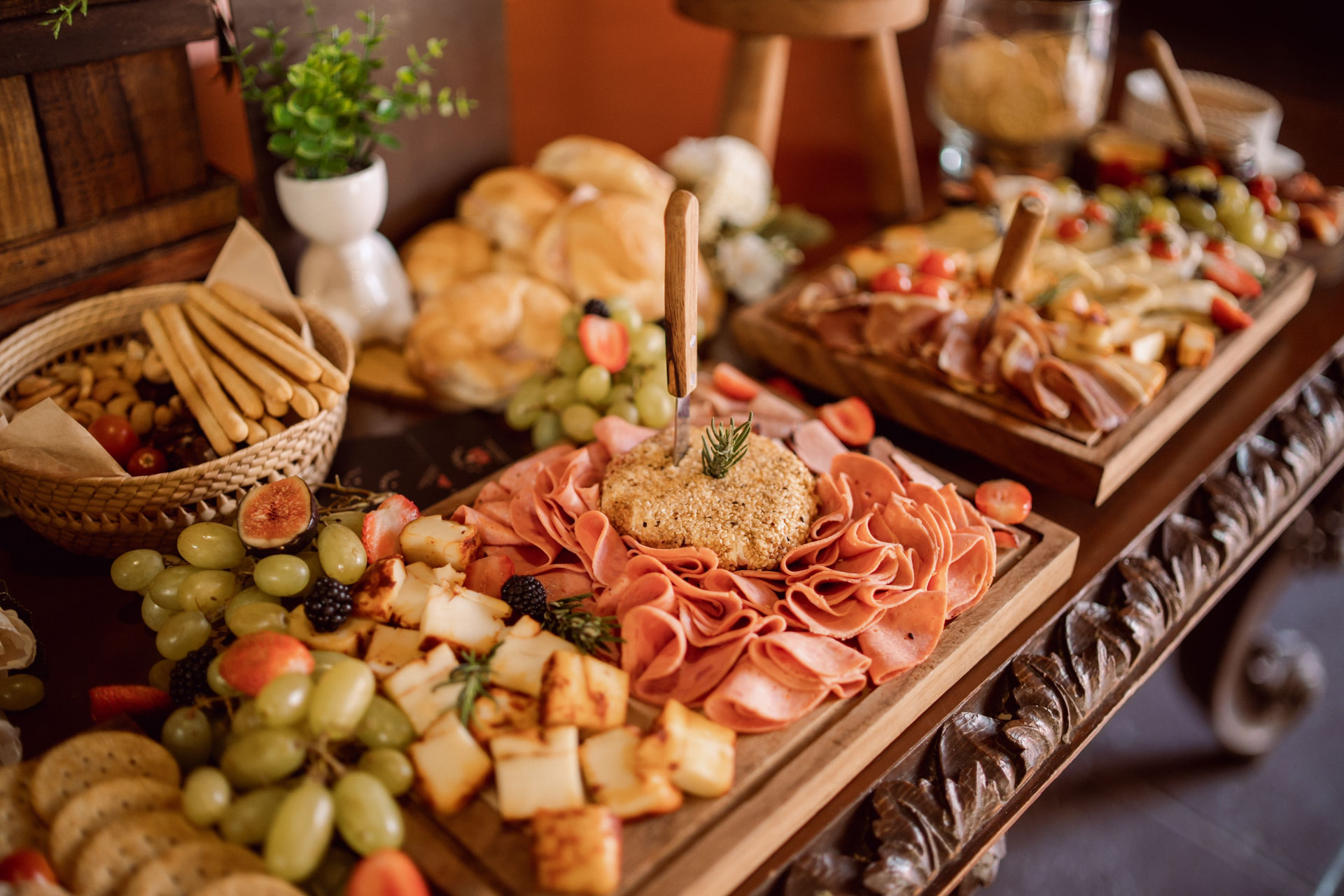 Cold meat, cheese and fruit grazing boards prepared for guests