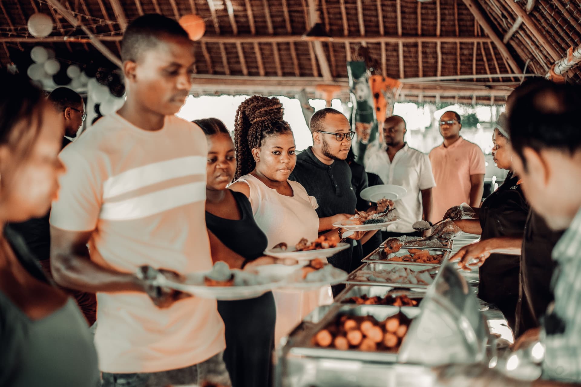 Guests being served along an organised catering service line